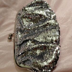 Limited Edition Silver Sequin Clutch Bag. Large round silver tone Closure.